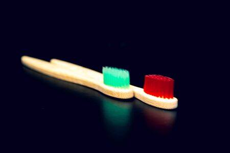 Dental and oral care products. Hygiene of teeth and oral cavity. Wooden toothbrush red and green....