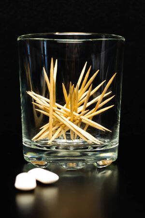 Toothpicks in a glass beaker. Dental and oral care products. Hygiene of teeth and oral cavity.の写真素材
