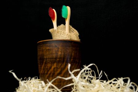 Wooden Toothbrushes in a Clay Cup. Dental and oral care products. Hygiene of teeth and oral cavity.の写真素材