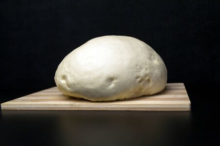 Air yeast dough on a black background