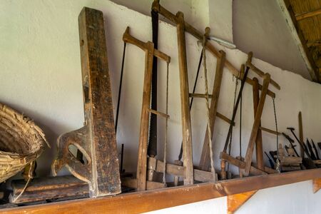 Old handmade tool, museum exhibit on a white background