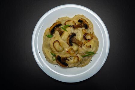 Dumplings in a white bowl. On a black backgroundの写真素材