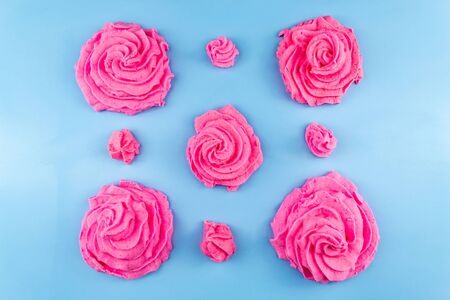 Pink sweet air marshmallow on a blue background Delicate dessertの写真素材