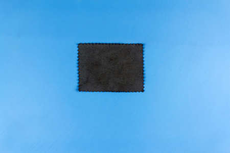 Gray patch on blue background close up