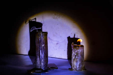 Two candles in the twilight vintage night room with shadow on background