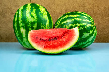 Close-up of fresh slices of red watermelon. Blue background