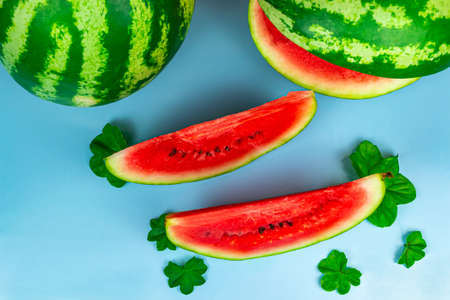 Close-up of fresh slices of red watermelon. Blue background