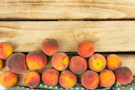View from above on peaches and a green napkin. Wood backgroundの写真素材