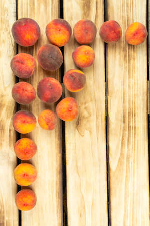 Top view on peaches, on wood backgroundの写真素材