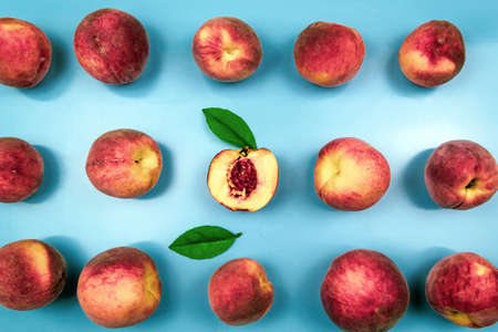 Background of ripe juicy peaches on blue close-up