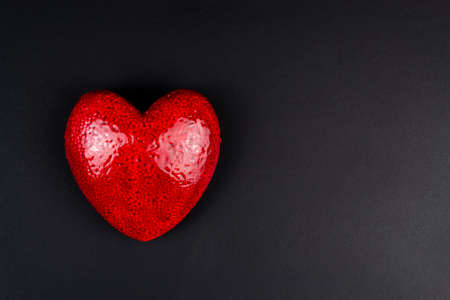 Top view of red heart on black background close upの写真素材
