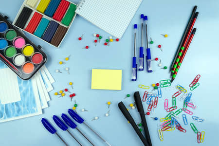 School supplies on a blue background. View from above.