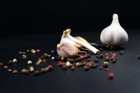 Organic garlic, pepper seasoning close-up. Black backgroundの写真素材
