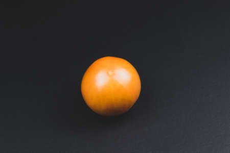 Red tomato on a black background. Close-upの写真素材