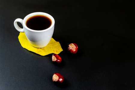 Cup of coffee, on a black background. Autumn conceptの写真素材