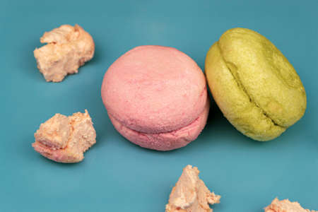 Macarons on a blue background with copy space.