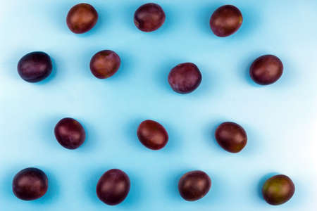 Many plums on a blue background. Close-upの写真素材