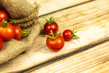 Tomatoes in a bag, on a wooden background. Close-upの写真素材