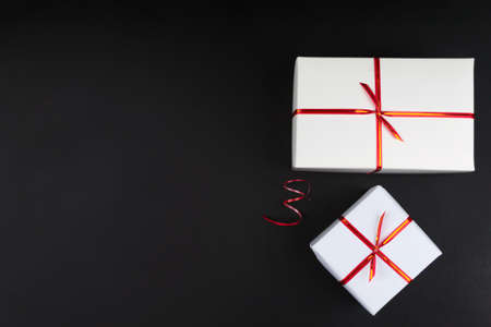 Two white gift boxes on black background, black friday conceptの写真素材