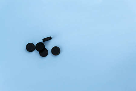 Activated carbon tablets on a blue backgroundの写真素材