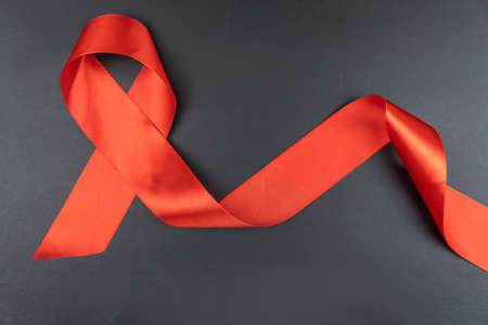 Red ribbon on black background aids dayの写真素材