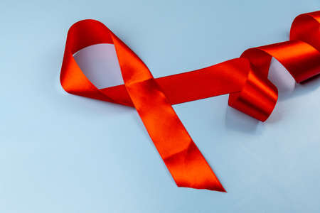 Red ribbon on blue background aids dayの写真素材