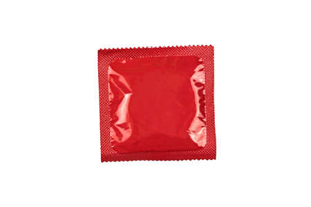 Condom in a red package close up on a white background. Contraceptionの写真素材