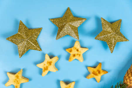 Christmas cookies in the form of stars and New Year's toys stars on a blue background. Close-upの写真素材