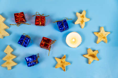 Christmas cookies candles gifts on a blue background. Close-upの写真素材