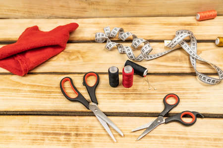 Accessories for sewing and sewing on a wooden background. Women's hobby