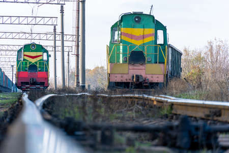 Two green locomotives on flights. Close-up - trains without wagons.