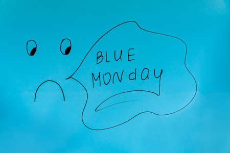 Drawn emoticon and Blue Monday lettering in black marker. Bad mood and sadness conceptの写真素材