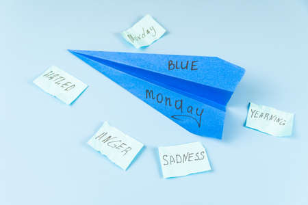 Blue plane with the inscription Blue Monday and a number of scattered sticky notes with...