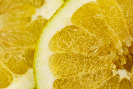 Close-up of pomelo slices. Citrus yellow fruit. Textured background from pomelo.の写真素材