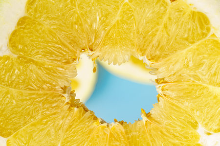 Close-up of pomelo slices. Citrus yellow fruit. Textured background from pomelo.の写真素材