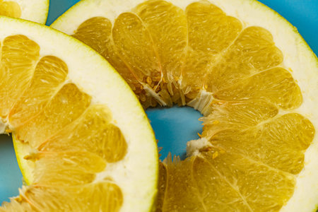 Close-up of pomelo slices. Citrus yellow fruit. Textured background from pomelo.の写真素材