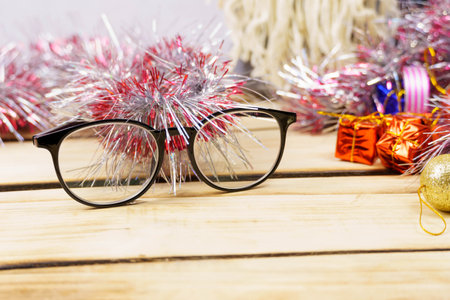 Glasses and Christmas decorations on a wooden background. Christmas background.