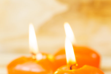 Red candles in the shape of a heart out of focus on a wooden background. The concept of dating, romance, love. Valentine's dayの写真素材