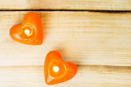 Top view of red heart shaped candles with copy space on wood background. Blurring the depth of field. The concept of dating, romance, love. Valentine's dayの写真素材