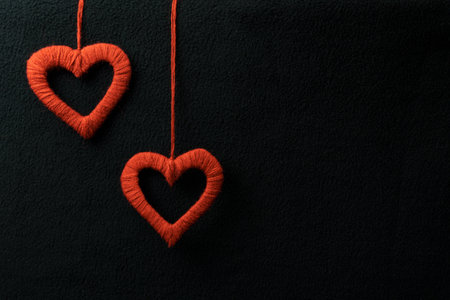 Two hearts on a black background. Free space for text. Greeting card for Valentine's Day.の写真素材