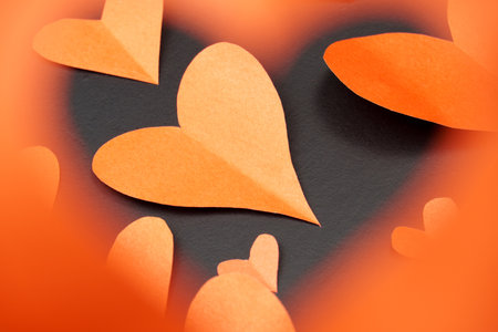 Red hearts on a black background. A look at hearts through a blurred heart. Valentine's day cardの写真素材