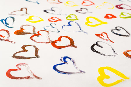 Multi-colored hearts drawn by paints on a white background. Valentine's day cardの写真素材
