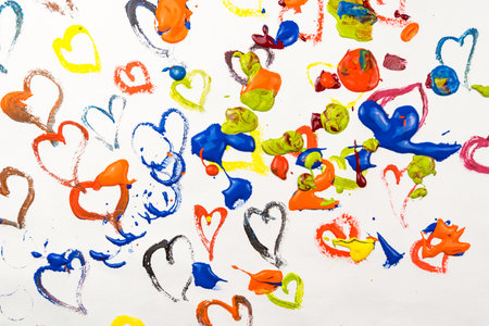 Many colored painted hearts splattered with paint on a white background. Love conceptの写真素材