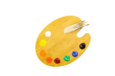 Wooden art palette with paints and brushes isolated on white background. Artist's setの写真素材