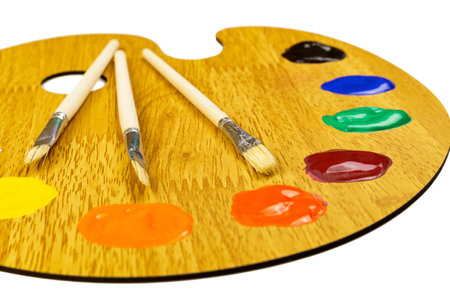 Wooden art palette with paints and brushes isolated on white background. Artist's setの写真素材