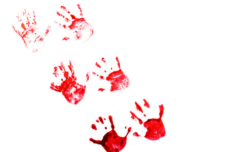 Many prints of human hands on a white background. Close-up of handprints