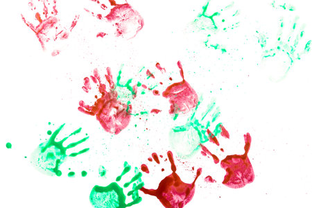 Red and green watercolor handprint of human hands on a white background. Close-up of handprintsの写真素材