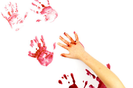 Red watercolor print of human hands on a white background. Close-up of handprintsの写真素材