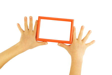 Red photo frame between children's hands isolated on white background. Photo layoutの写真素材