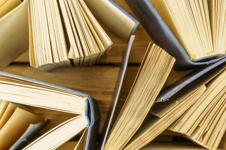 Close-up of old hardback books on wood background. Background from books top view. Open books, flipped pages. World book dayの写真素材
